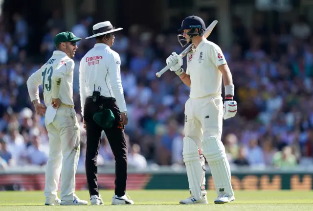 Umpire Kumar Dharmasena talks to Joe Root and Matthew Wade