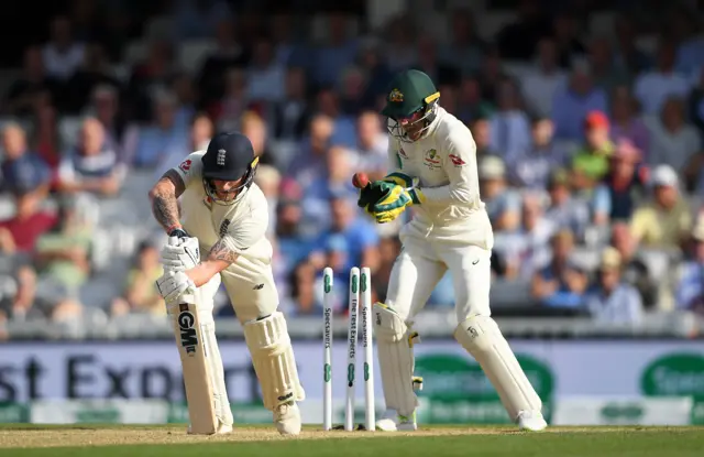 Ben Stokes of England is bowled by Nathan Lyon of Australia as Tim Paine looks on during Day Three of the 5th Specsavers Ashes Test between England and Australia at The Kia Oval