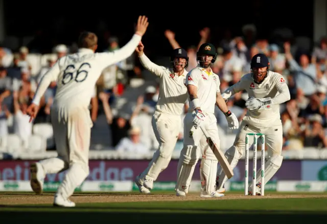 England players celebrate the wicket of Australia's Matthew Wade before the decision is overturned following a DRS review