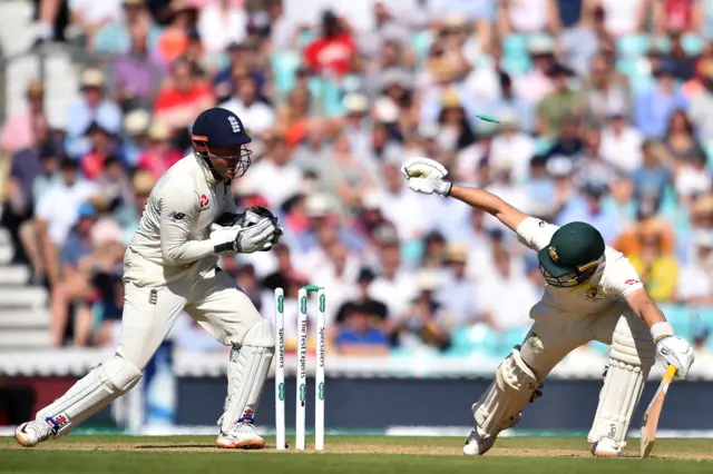 England's Jonny Bairstow takes off the bails as he stumps Australia's Marnus Labuschagne (R) during play on the fourth day of the fifth Ashes cricket Test match between England and Australia at The Oval