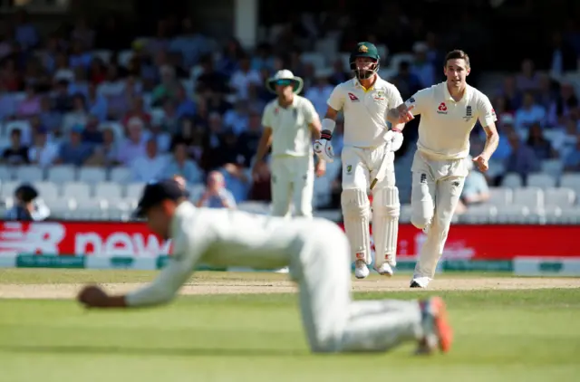 England's Chris Woakes looks on as Rory Burns takes a catch to dismiss Australia's Mitchell Marsh before the decision is overturned due to a no ball delivery