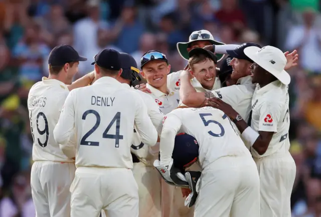 England's Joe Root celebrates with teammates after taking a catch to dismiss Australia's Josh Hazlewood to give England victory in the fifth Test