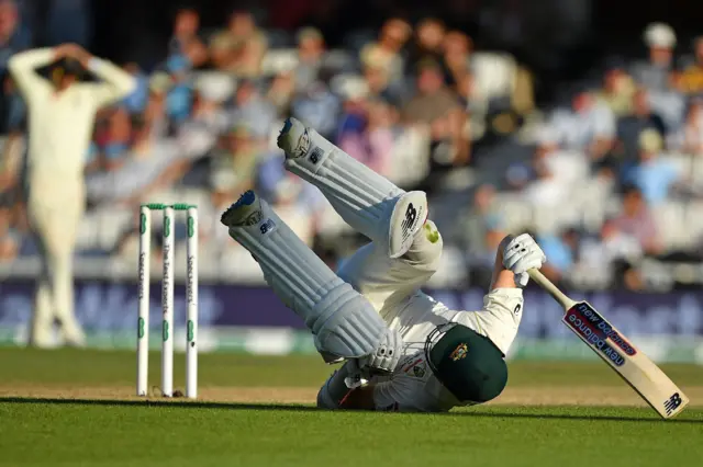 Matthew Wade ends in a heap on the floor after just making his ground