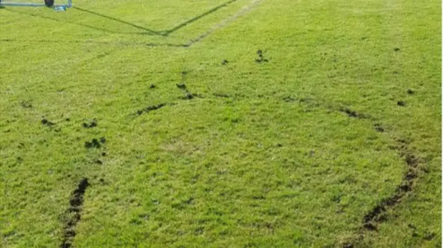 Bike tracks on football pitch