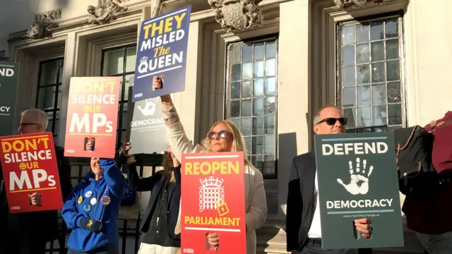 Protesters outside the Supreme Court in London where judges are due to consider legal challenges to Prime Minister Boris Johnson