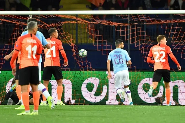 Riyad Mahrez looks straight towards the assistant referee after opening the scoring for Manchester City