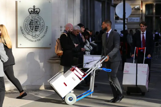 Boxes of legal documents are wheeled in to the Supreme Court, London, where judges are considering legal challenges