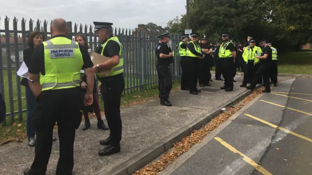 Officers outside the prison