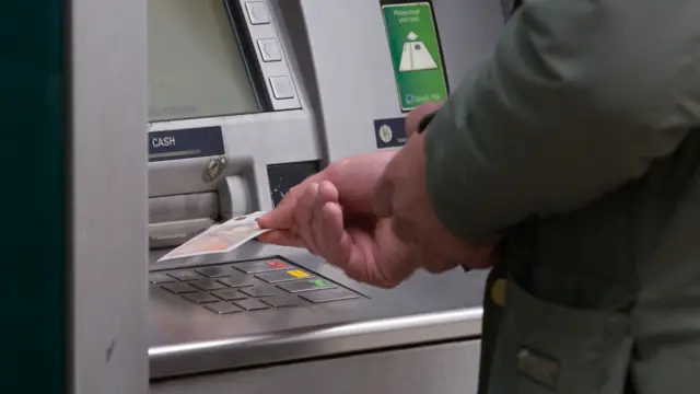 Man withdrawing money from an ATM.