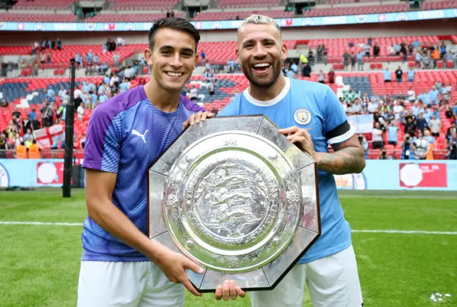 Eric Garcia, left, holding the Community Shield with with Nicolas Otamendi