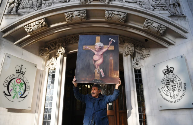 Satircal artist Kaya Mar protests outside the court