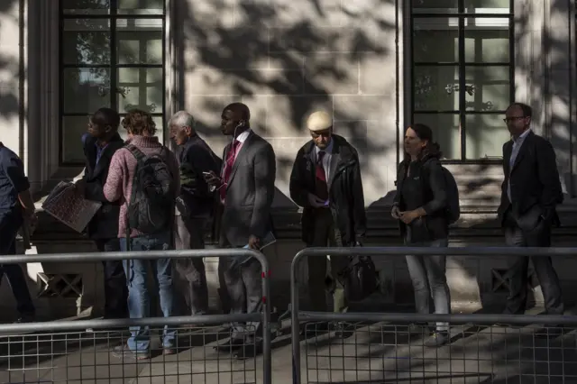 Members of the public queue outside the Supreme Court