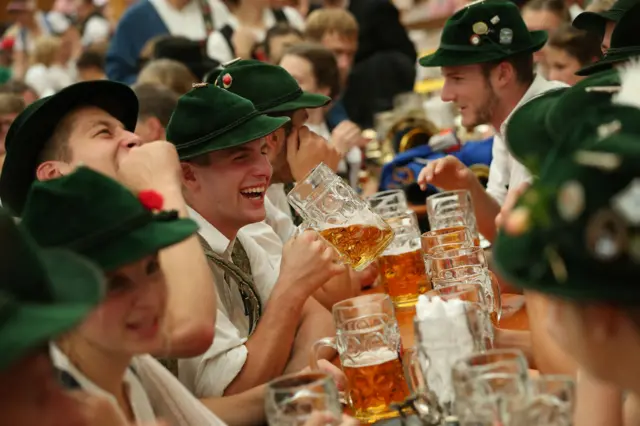 People drink beer at Oktoberfest 2018