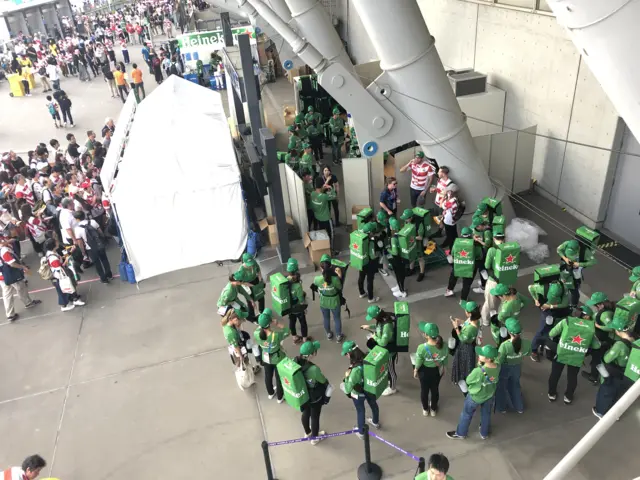 A group of people who will give beer to fans in the crowd