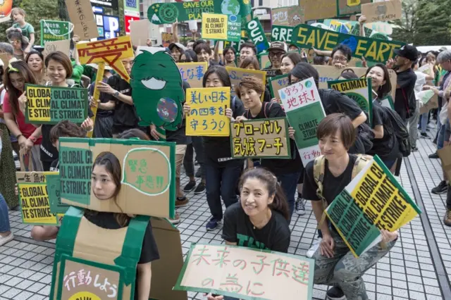 Protesters in Tokyo, Japan, holding signs in Japanese