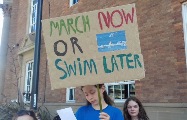 Young person holding banner