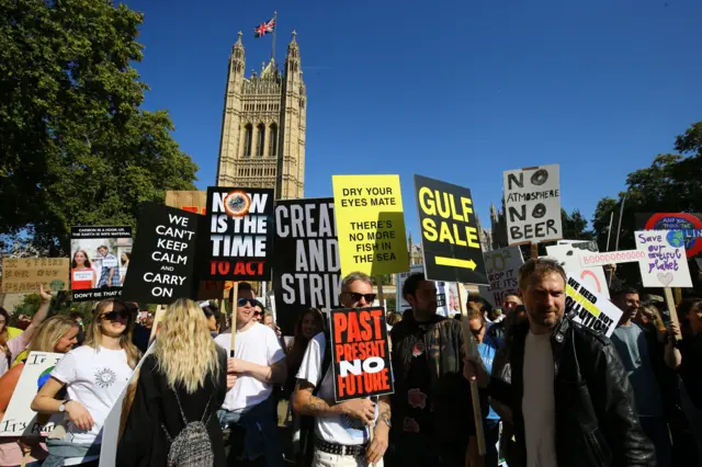 Protesters in London carrying placards