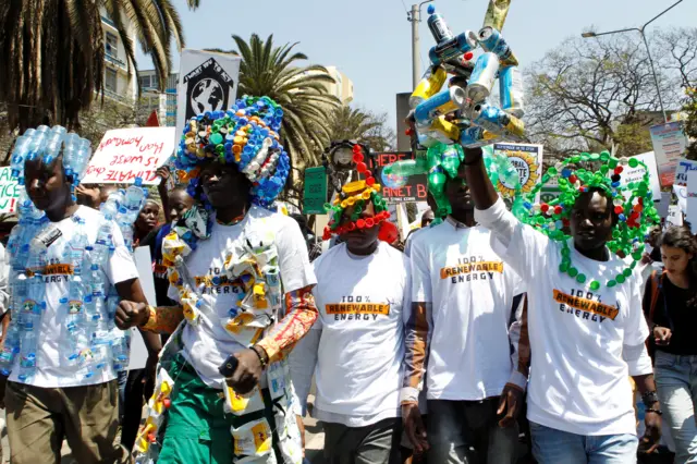 Protesters wearing brightly coloured recycled plastic accessories