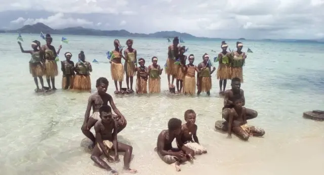 Young activists on a beach in Marovo Island, the Solomon Islands