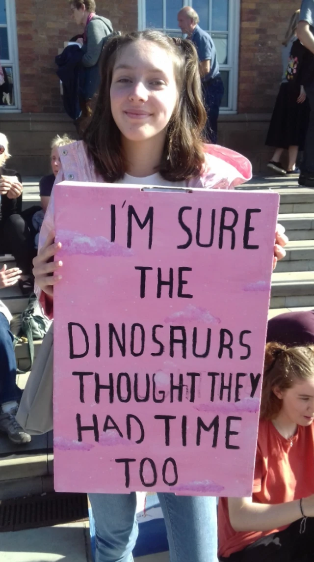 Young person holding banner