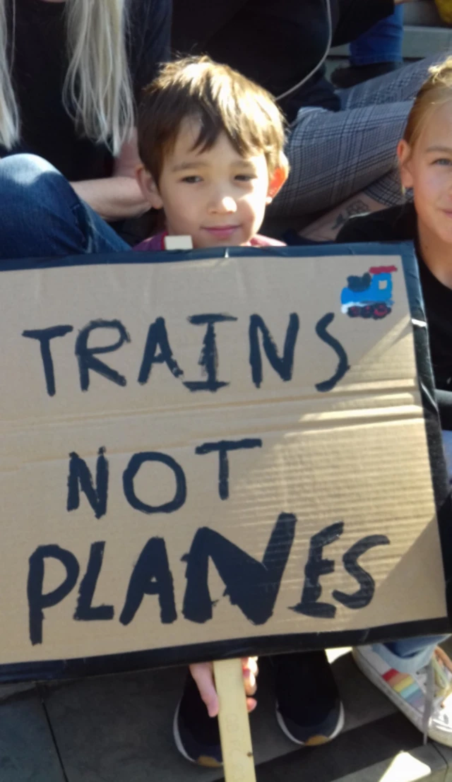 Young person holding banner