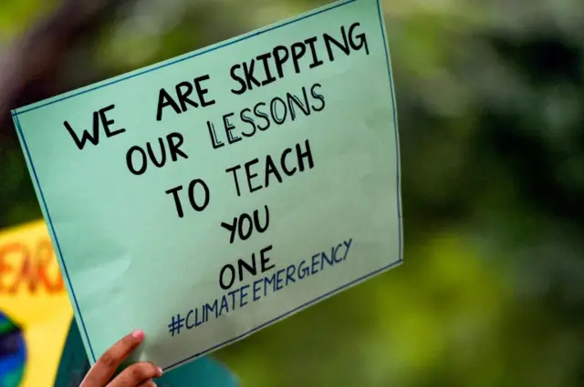 Sign in New Delhi reads: "We are skipping our lessons to teach you one"