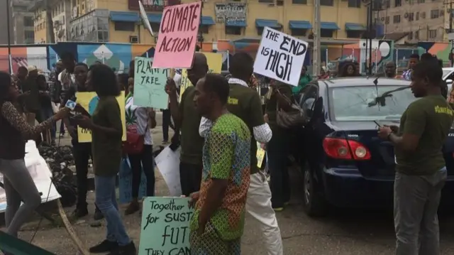 Protesters in Lagos carrying placards