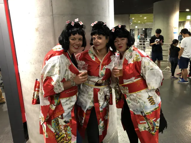 Three women dressed as geishas