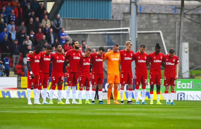 Rangers players lock arms during their Fernando Ricksen tribute