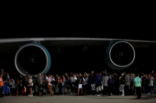 Thomas Cook passengers at Dalaman Airport in Turkey board a plane to the UK