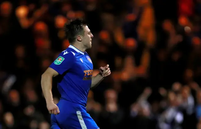 Tom Lapslie celebrates scoring the winning penalty