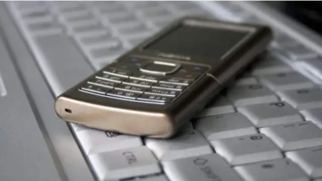 Phone on a computer keyboard