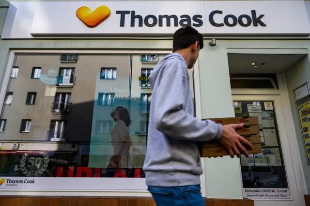 Man in front of Thomas Cook shop