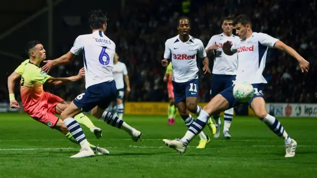 Phil Foden fires a shot goalwards but it rattles the crossbar