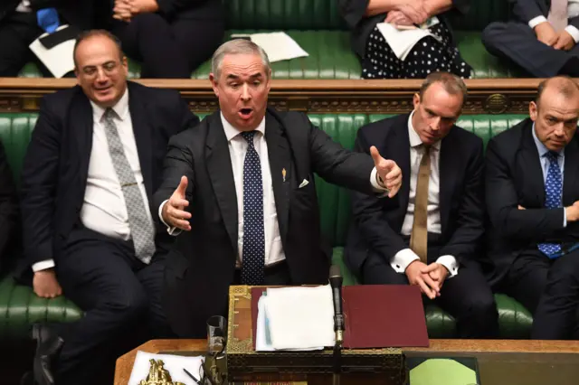 Attorney General Geoffrey Cox gesturing while answering questions