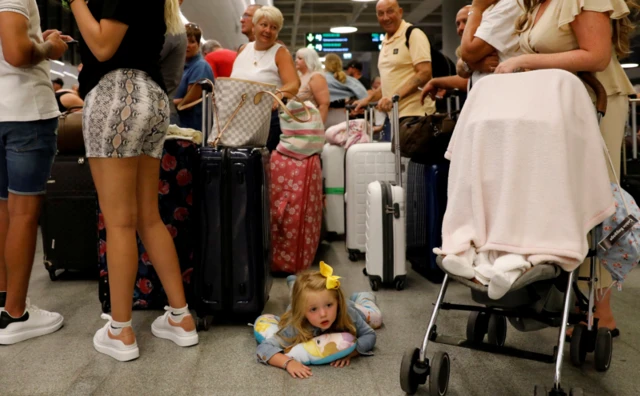 Thomas Cook customers queue up to get on a flight back to the UK