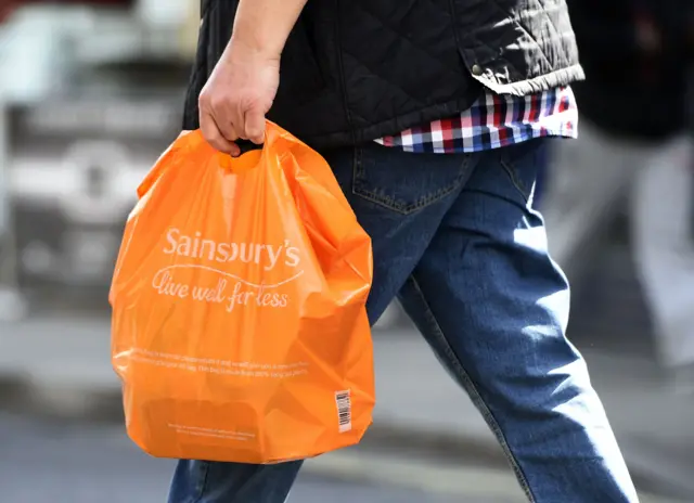 Man with Sainsbury's shopping bag