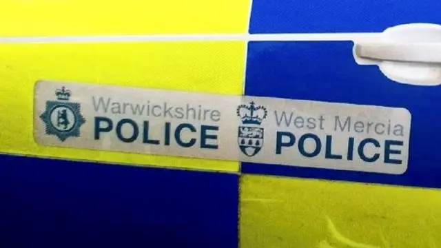 Two police forces names on car door