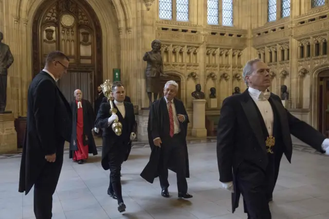 John Bercow (C) walking beside the Serjeant-at-Arms carrying the mace on their way to the House of Commons in London on September 25, 2019, to resume a session in Parliament