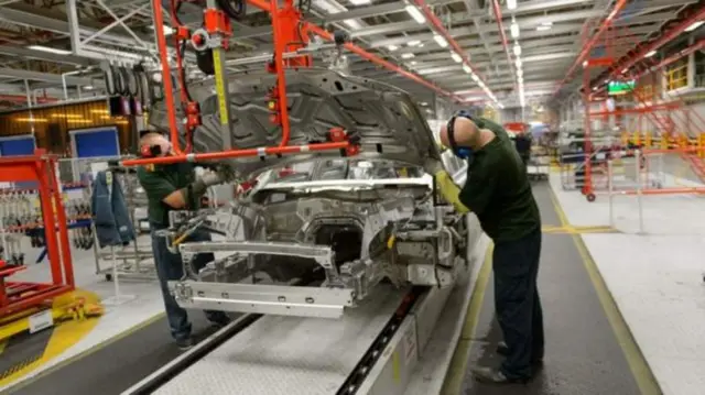 Workers in a Jaguar Land Rover factory