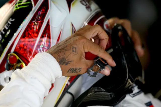 Lewis Hamilton's hand with a 1985 tattoo