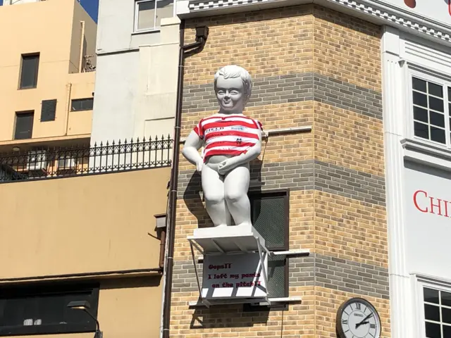 A giant Manneken Pis statue with a Japan shirt on