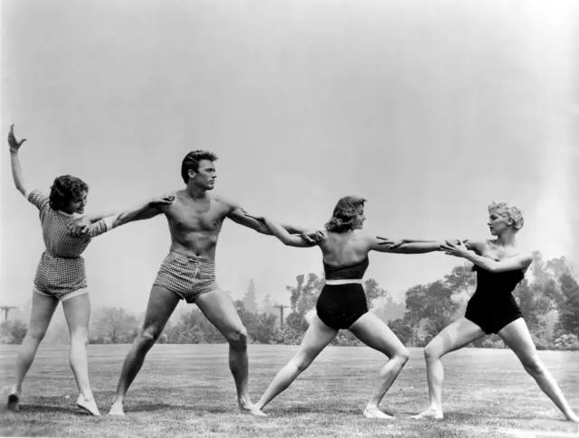 Universal's talent workshop included a regular course in body conditioning. American actor Clint Eastwood is surrounded by Jane Howard, Myrna Hansen and Dani Crayne