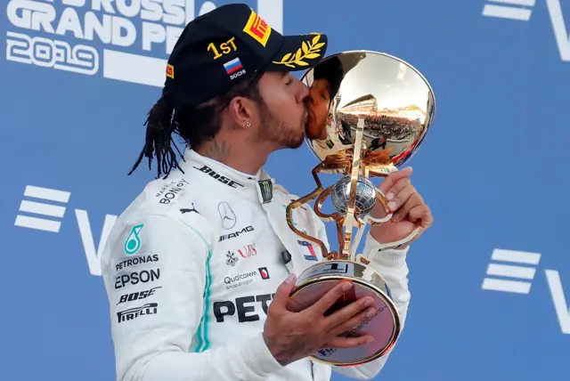 Hamilton kisses the trophy