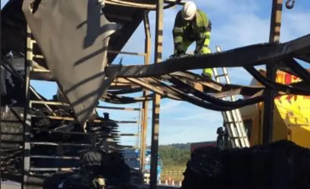 Workmen clearing crashed lorry