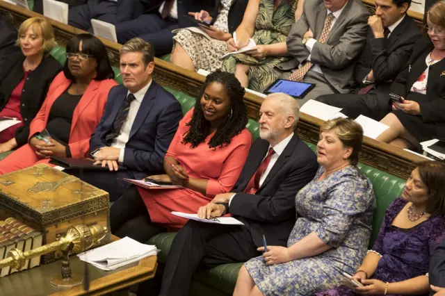 Jeremy Corbyn is surrounded by his frontbench colleagues as they listen to the government