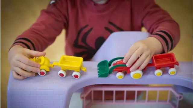 Child playing with tractors