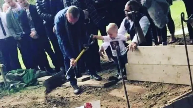 A boy with a spade