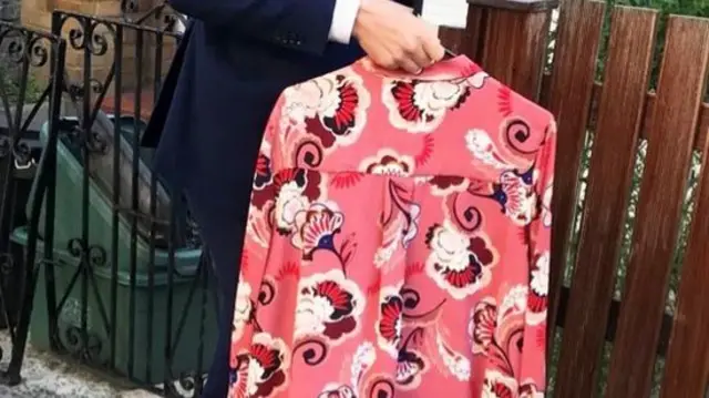 Corbyn was handed a pink floral shirt outside his home on Thursday morning after Boris Johnson called him a big girl's blouse