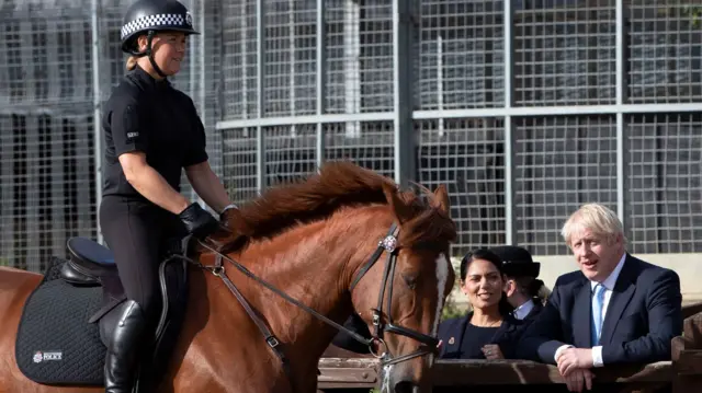 Boris Johnson sees an officer on a horse